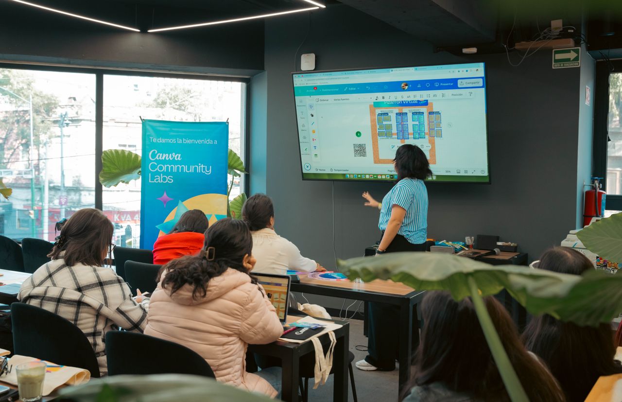 Mastering the First Impression: Your intriguing post title goes here Interactive workshop session at Canva Community Labs with a presentation screen and engaged audience.